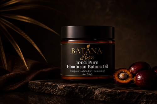 Batana Luxe Batana Oil jar on dark stone with palm fruit